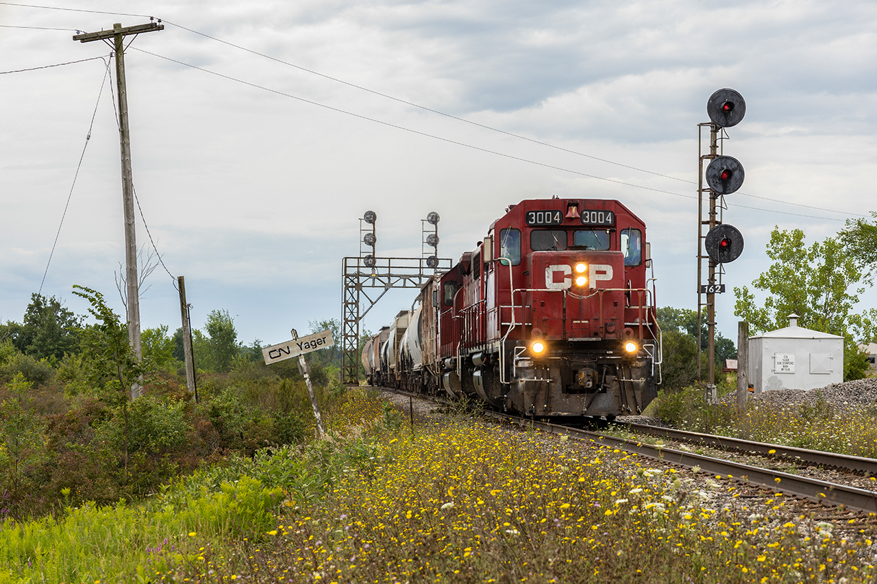 A classic original CP GP38AC and a former D&H GP38-2 take a handful of cars to the CN interchange at Southern Yard, about a mile behind the camera.