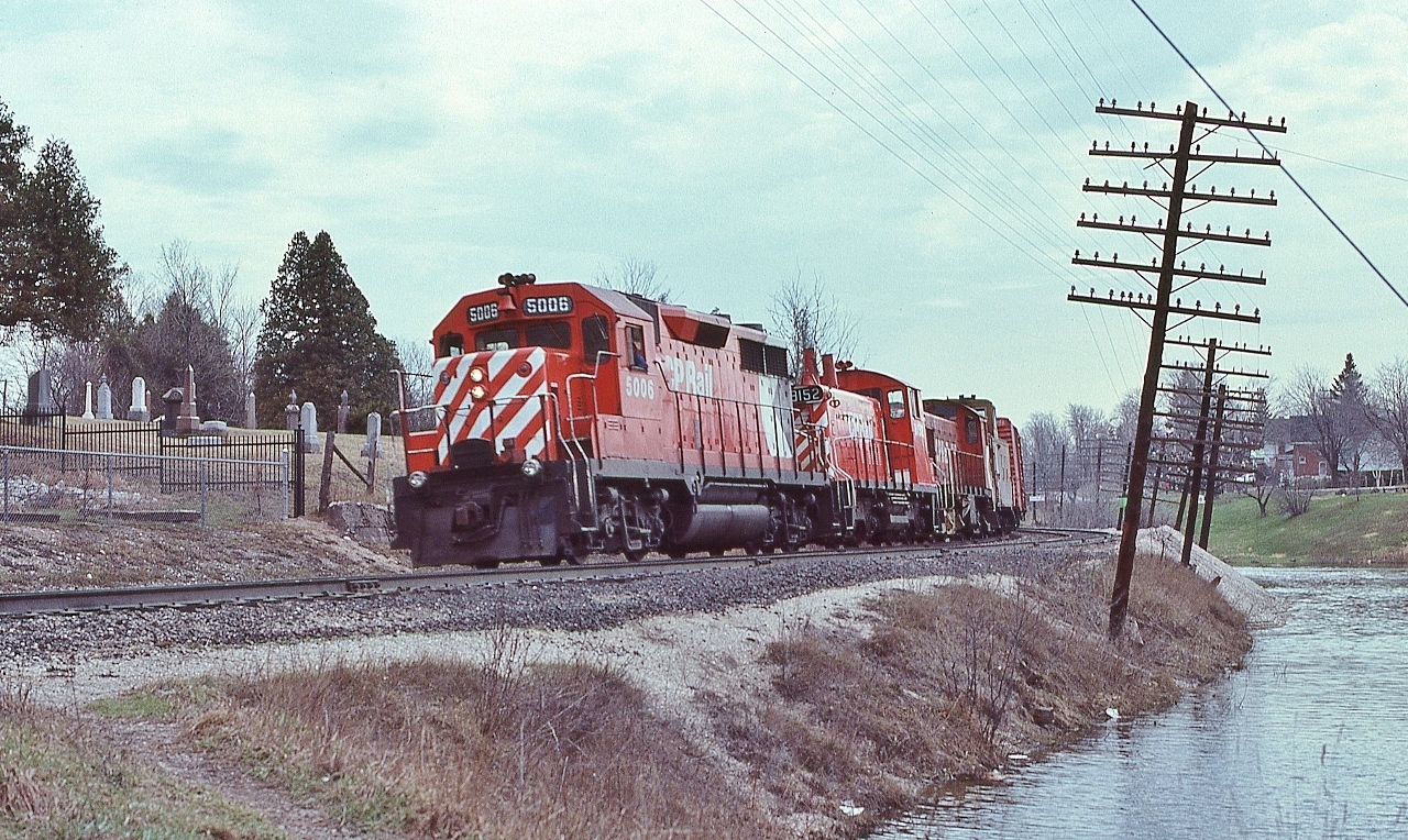 The Seventies C P Rail ...


   ….when every lashup was an adventure in motive power variety..... 


    ….GMD – GMD - MLW combo: GP35 and SW1200RS is assisted by a  MLW  'ugly 80'  RS-23


     accelerating on the downgrade at the Campbellville Road crossing, April 7, 1979 Kodachrome by S.Danko


   Note the location of 5006's marker lights ... a GP35 leading ! ? !


   Given no flags, no markers illuminated, this is a regularly scheduled train, likely this is fourth class  #52 (?)