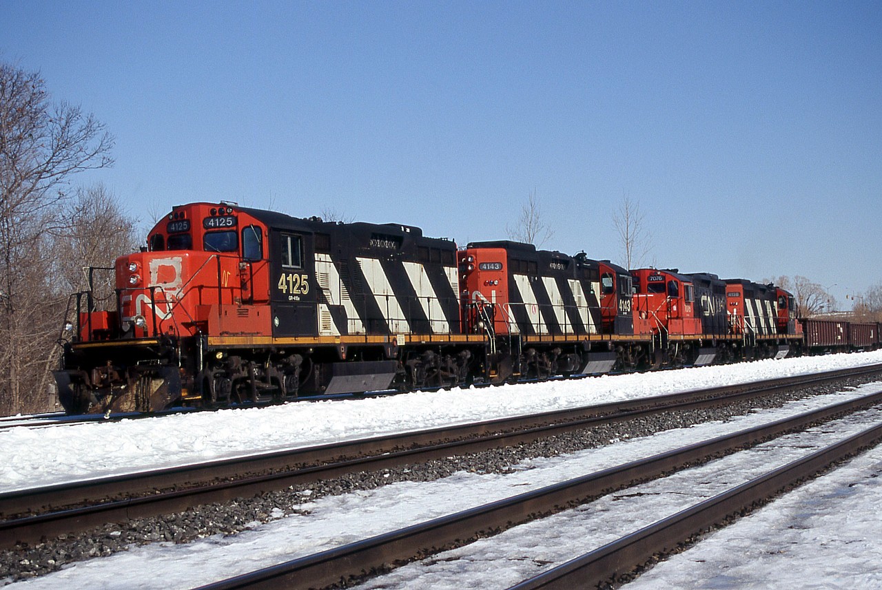 A quartet of CN GP9RMs pull down one of the yard leads while switching the west end of Aldershot Yard.  CN 4125 and CN 4138 (1st and 4th) are still on CN's roster; 4138 being the unit lettered "AR Illinois" for it's appearance in the 1997 movie "The Wrong Guy" that never got its CN noodle back.  CN 4143 was sold to Lampton Diesel Service, and then to Cando, now CCGX 4016.  CN 7076 was sold to Indiana Boxcar Company, as IBCX 7076. I think this is the only time I saw four GP9RMs together in a consist.