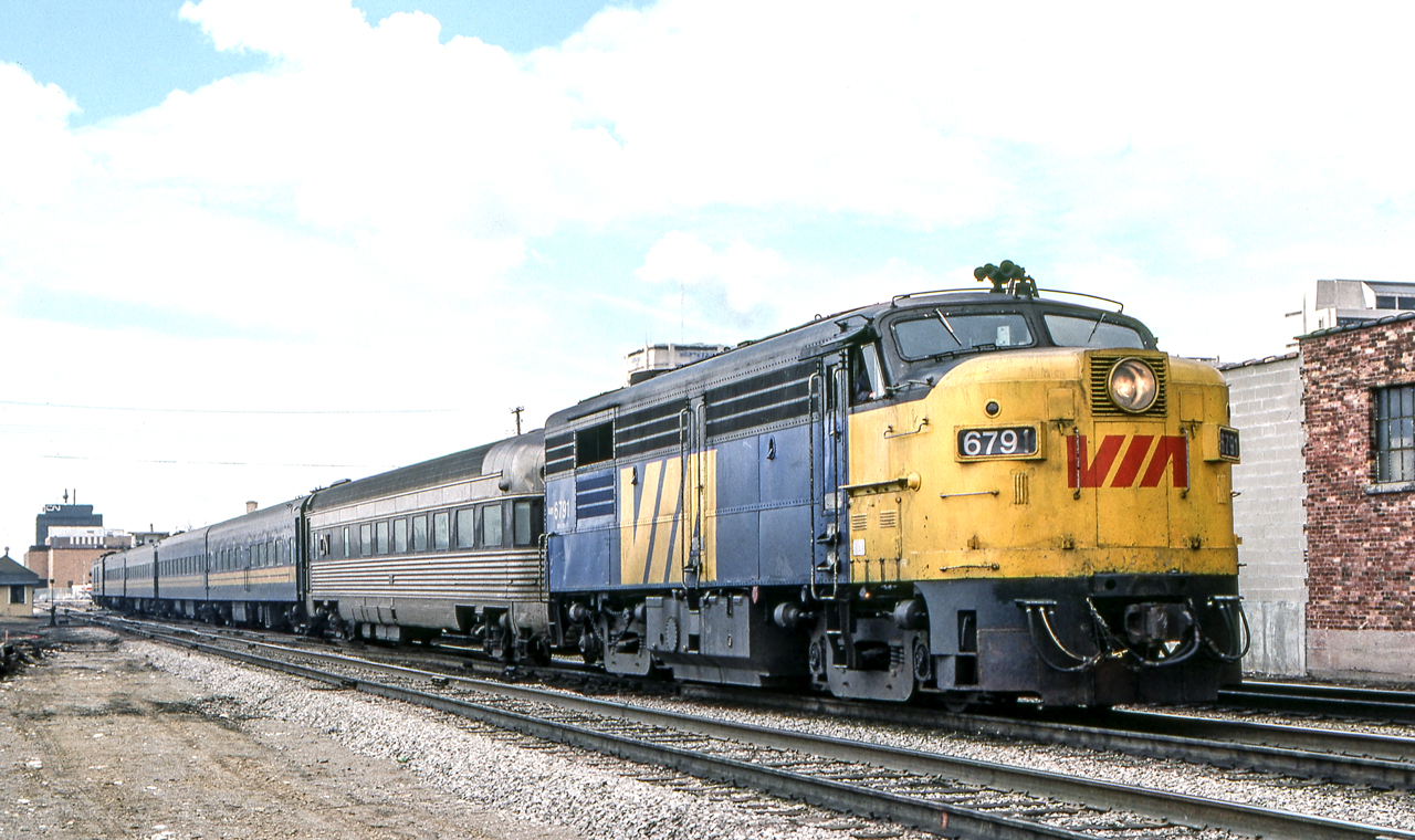 Eastbound VIA 6791 has just left the VIA station in London, Ontario on March 24, 1981.