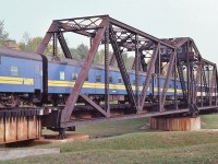    <br>
<br>
    Trains, Bridges, Waterways .....
<br>
<br>
    FP9A 6504, a F9B and another FP9A are in charge of VIA #3 SUPER CONTINENTAL.... 
<br>
<br>
    ….on the Super C's tail end: two E series sleeping cars, two River series –  one in CN livery – sleeping cars and a baggage.
<br>
<br>
   at the CN Drawbridge mile 89.9 Bala Subdivision, September 29, 1979 Kodachrome by S.Danko
<br>
<br>
    Q: When the bridge is a swing bridge, why do the railways call such Interlockings a 'Drawbridge'??
<br>
<br>
   Notable: The Bridge Tender's shanty has been re-sided in white and as of August 2014 was in situ. More recently appears to have been replaced by a trailer. Drawbridge is in service May 1 to October 15. 
<br>
<br>
   Noteworthy: The CN Drawbridge is in a park like setting on the Trent Canal main channel between Sparrow Lake ( north) and Lake Couchiching ( south). The bridge is CN controlled, Trent Canal mile 209.1 (from Trenton at mile 0.0), upon approach boaters must observe the bridge status...the bridge crossing is not signaled for boaters ( Locks are signaled) and for boaters  “ is always a bonus when the bridge is open ”' …. and if a wait required ' not fun ' on a windy day. Boaters' wait  times for clearance (swing time plus train time and opening swing time ) can be upwards of 20 minutes. 
<br>
<br>
    Lock 42, the Couchiching Lock, Trent Canal mile 209.9 (from Trenton mile 0.0) is a few hundred yards to the north.
<br>
<br>
    E sleeping car, built for CNR: fifty two in the series (as of 1973): built 1952, 70 tons, 4 sections, 8 duplex roomettes, 4 double bedroom, examples #1137 Enfield, #1159 Eldorado
<br>
<br>
   River sleeping car, purchased by CNR from various roads: twenty from NYC in 1965, five from MILW in 1965, twelve from FEC in 1967, five from EL in 1967: as of 1973 forty seven in the series: most built 1949, 65 to 74 tons, 10 roomettes, 6 double bedrooms, examples CN #2131 Grand Codroy River (ex FEC Argentina), CN #2086 Pembina River (ex NYC 10199 Chicopee River). [source UCRS CNR Passenger Equipment binder]
<br>
<br>
    More Trains, Bridges, Waterways, adding Boats and Marina:
  <br>
<br>
     <a href="http://www.railpictures.ca/?attachment_id=  44247 ">  mile 88.4 </a>
<br>
<br>
   sdfourty
