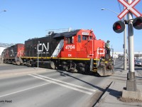 On a gorgeous late winter afternoon, The CN 15:00 Yard Job eases ahead with CN 4704 and CN 7038 as it crosses Burlington St. in Hamilton's Northend Industrial area. 