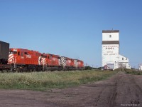  CP No 401 heads Westward past the grain elevator at Red Jacket SK on July 10th 1978. I was returning East on a family trip to the mountains. My Dad had bought a Jayco trailer and we were camped that night close to the tracks. This shot was about 7am and the 'coming' shot was right into the sun. The going away shot was better and more interesting anyway. 