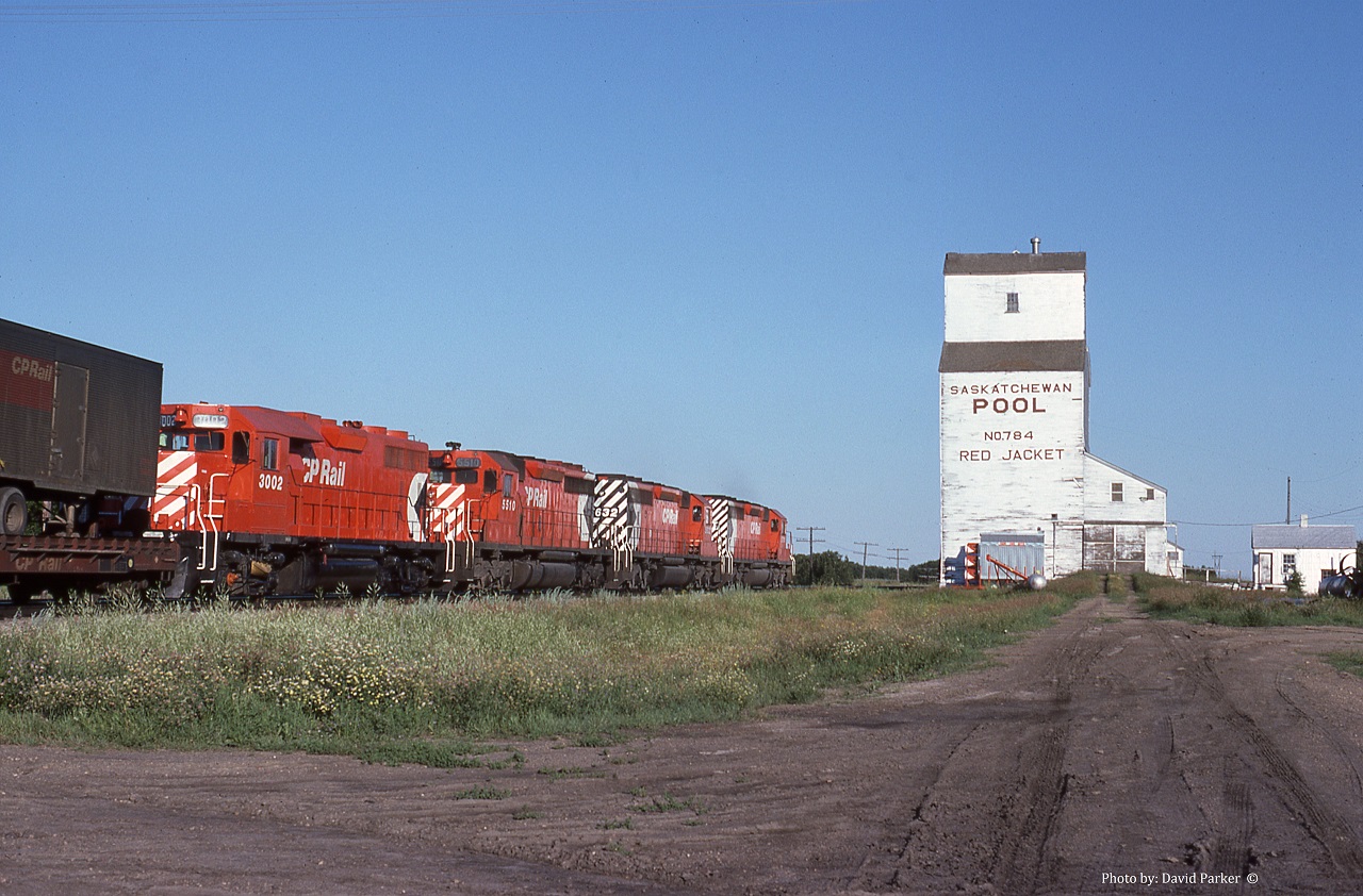 CP No 401 heads Westward past the grain elevator at Red Jacket SK on July 10th 1978. I was returning East on a family trip to the mountains. My Dad had bought a Jayco trailer and we were camped that night close to the tracks. This shot was about 7am and the 'coming' shot was right into the sun. The going away shot was better and more interesting anyway.