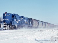  The Conrail St Thomas to Windsor local WQST-4 kicks up the snow as it passes through Tilbury, Ont led by Canada Division GP9 7440 and GP7 5826. Trailing the four CN covered hoppers is the Comber set-off consisting of CN heater cars for Heinz in Leamington. 