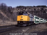 For a period of time in 1992 Via's LRC car fleet was sidelined with some mechanical issues (something to do with the trucks, if I recall correctly). In their place Via rented some Go Transit bilevels. The non-reclining seats did not make for the most comfortable ride, at least compared to what you normally go with Via, I seem to remember that you got a 50% off coupon if you had a train with Go equipment. 

In this scene #73 is passing the former station site at Dundas, under Dundas Peak. 