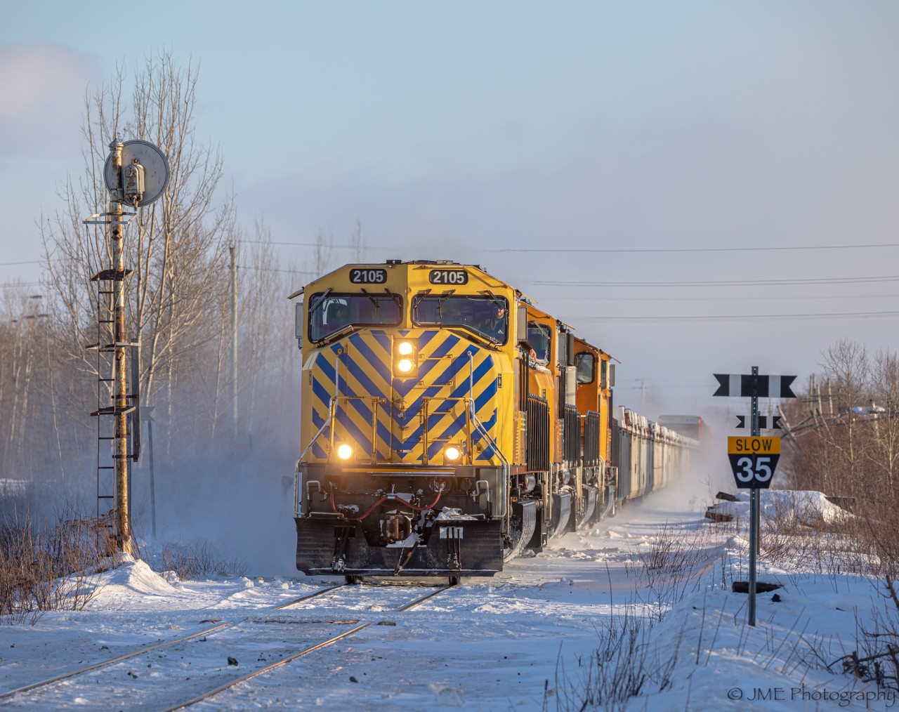 ONT 113 passes an old searchlight signal, at outside of Temiskaming Shores that once used to light the right of way for trains on the Temagami Subdivision. The crew on this train loved to have their pictures taken, if you could notice the pose the conductor is giving.