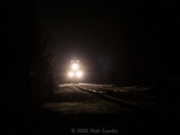 About 30 minutes before sunrise, CN 121 lights up the track getting up to speed approaching Berry Mills, New Brunswick.