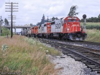 A quartet of SD40-2s westbound through Puslinch, passing beneath Highway 6.  The east back track switch in the foreground would be pulled in just a few years.  Lead unit 6603 was scrapped by K&K in 2017, and second unit, 6615, was rebuilt to SD30C-ECO 5048 in 2016.