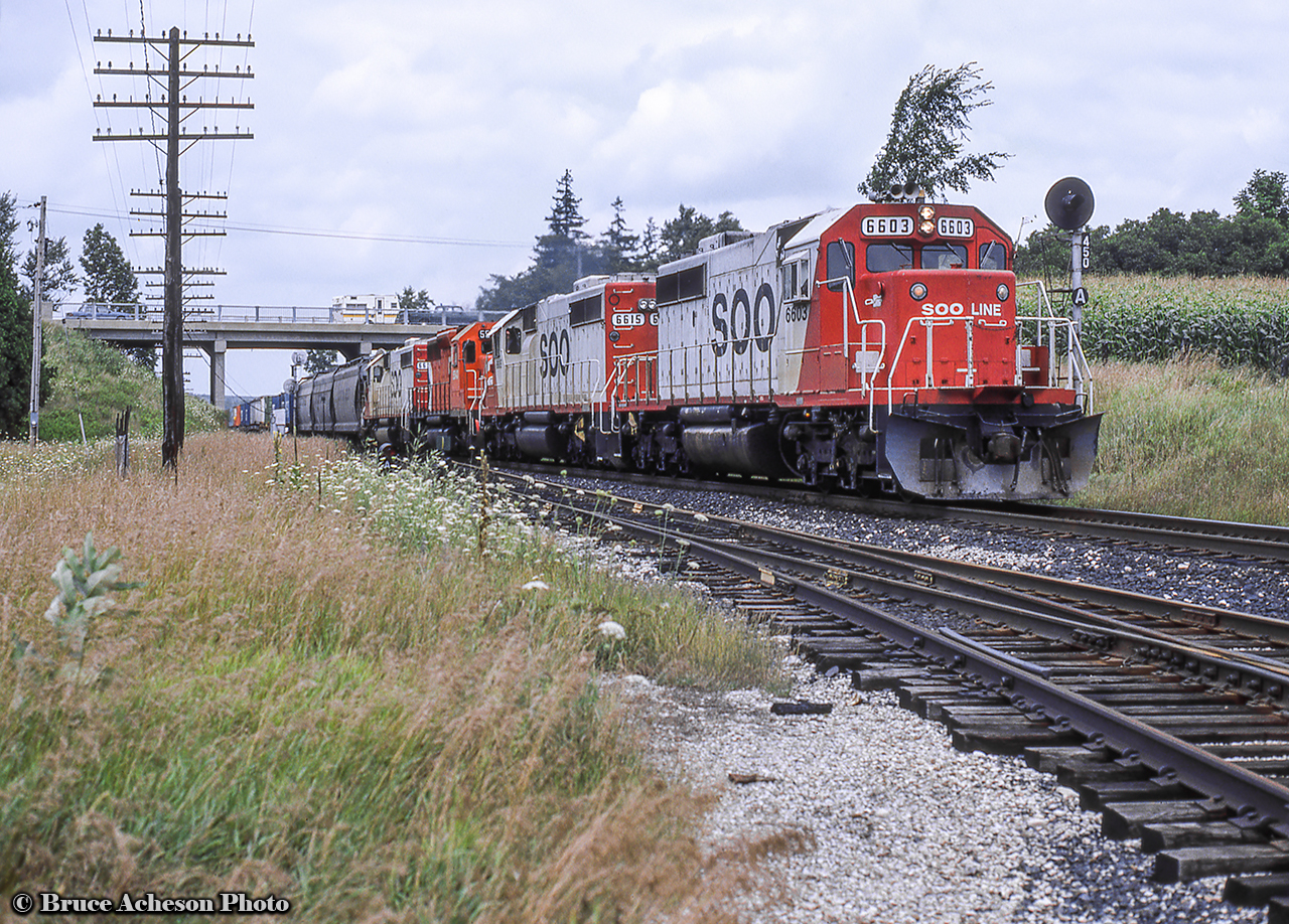A quartet of SD40-2s westbound through Puslinch, passing beneath Highway 6.  The east back track switch in the foreground would be pulled in just a few years.  Lead unit 6603 was scrapped by K&K in 2017, and second unit, 6615, was rebuilt to SD30C-ECO 5048 in 2016.