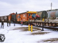 Its not just roads and sidewalks that need salt or sand to keep their surfaces safe, railyards need it too.  On a visit to Mimico Yard in February 1985, Bruce Lowe captured a yard crew dropping sand along one of the ladder tracks, shoveling it off the deck of a flatcar modified with timbers to keep the sand on the car.

<br><br>GMD SW900 7206, built 1953, would be renumbered to 7906 very soon, along with the rest of the series, to clear the 7200 series for GP9RM rebuilds, the earliest of which appeared in June 1985.