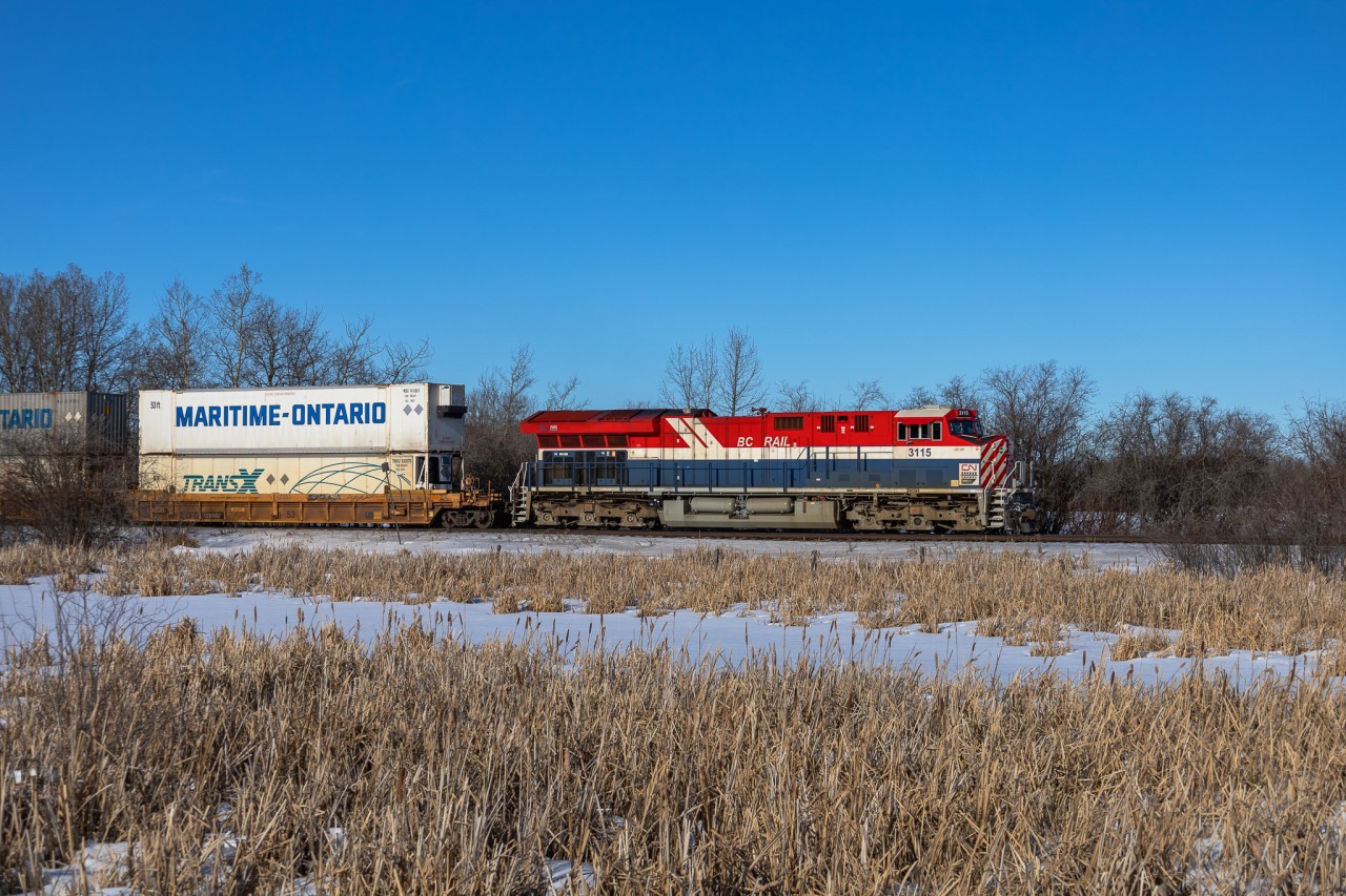 CN 3115 the BC Rail Heritage unit rolls past a frozen swamp just north of Looma, Alberta