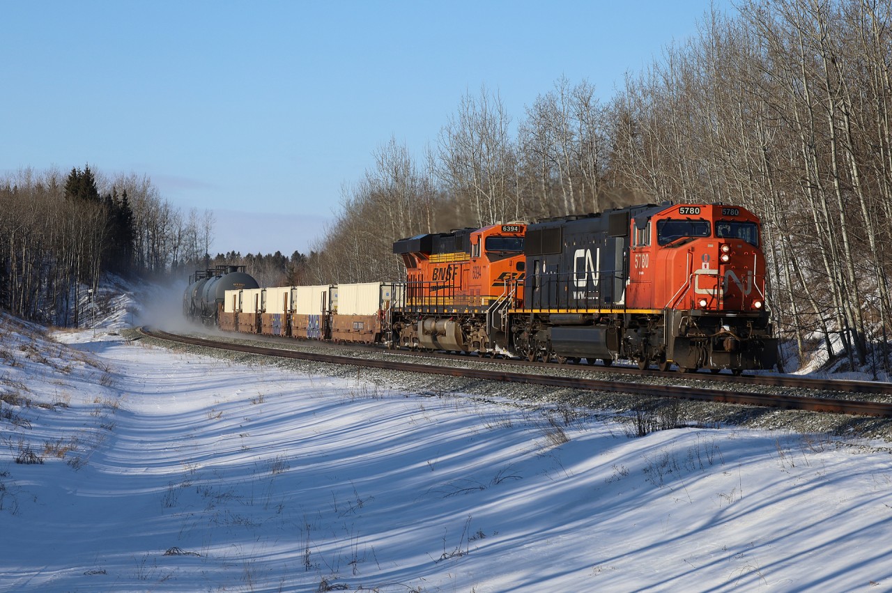 M 35651 30 highballs through Stony Plain with CN 5780, BNSF 6394 and 139 cars.