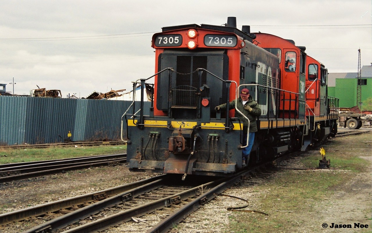 I don’t exactly know where this photo was taken as I believe it was a bail out of the car and get your shots situation. According to the negatives it might be CN 7305 and CN 7031 reversing into the then Stelwire Parkdale Works facility in Hamilton’s industrial core, which is now a current ArcelorMittal facility up on Strathearne Ave north of Strathearne Yard.  Corrections and information are appreciated.
