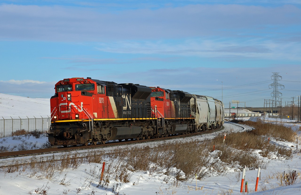 S 77181 05 rolls into Edmonton with 187 frac sand cars, with half the train bound for Leslieville, Alberta on the Brazeau Sub (near Red Deer) and the other half bound for Grande Prairie.  Todays consist was CN 8813, CN 8889, mid train remote KCS 5024 and another mid train remote CN 8852.  If you look closely, you can see the KCS unit between the power poles