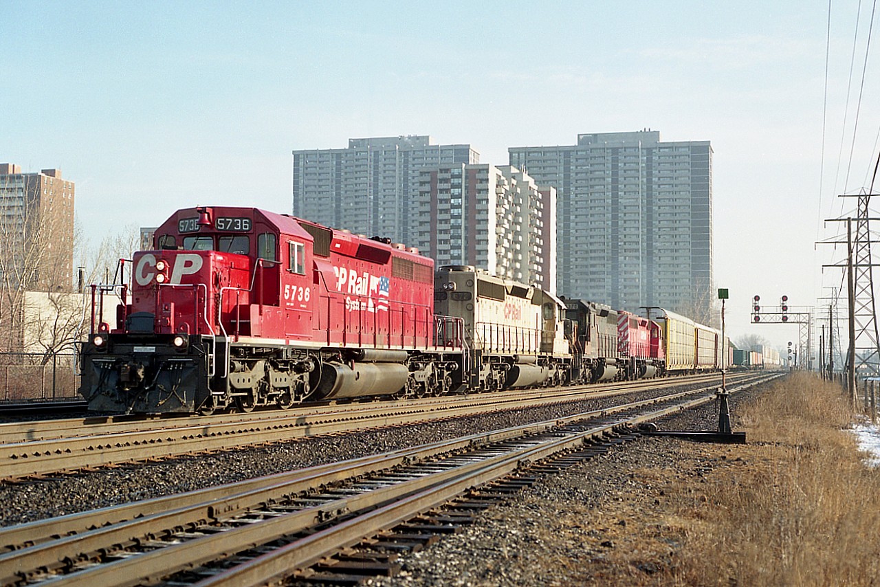 I liked the days of 'colour' on CP. The mid 90s featured so many leased units. Such a change from the same old red.  Pity the sun was harsh on the side as this train rolled west, but it couldn't be helped. Seen is CP 5736, CP 672 (x-KCS), HLCX 6570 and CP 5591. Haven't been back there in a long time. Wonder if the location is still accessible.
