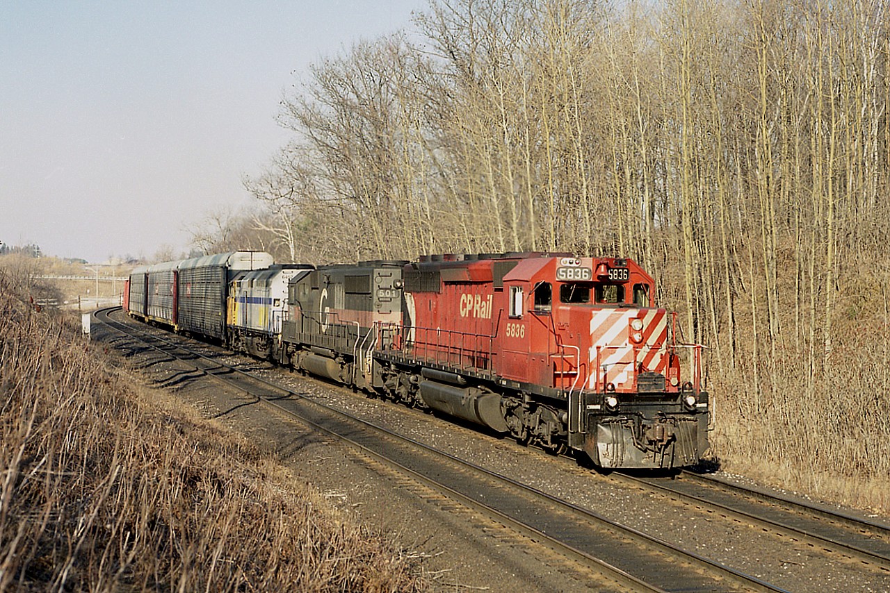 The leasing frenzy of the mid 1990s.  Here is an almost typical westbound approaching Campbellville, with the odd assortment of CP 5836, HATX 501 and VIA 6452.  It seemed anything that rolled was good enough. And the very late afternoon sun was a delight.