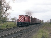 As a wayfrieght trundling along thru the countryside, this image has "yesteryear" draped all over it. It is something we just do not see any more. The view is on the Belleville Sub just to the west of Perth, Ontario, and the venerable old CP ALCO S-2 #7025 is on its last legs. Built in 1944, the unit was scrapped at Angus barely over a year after this photo was taken. The end came in early June of 1982.