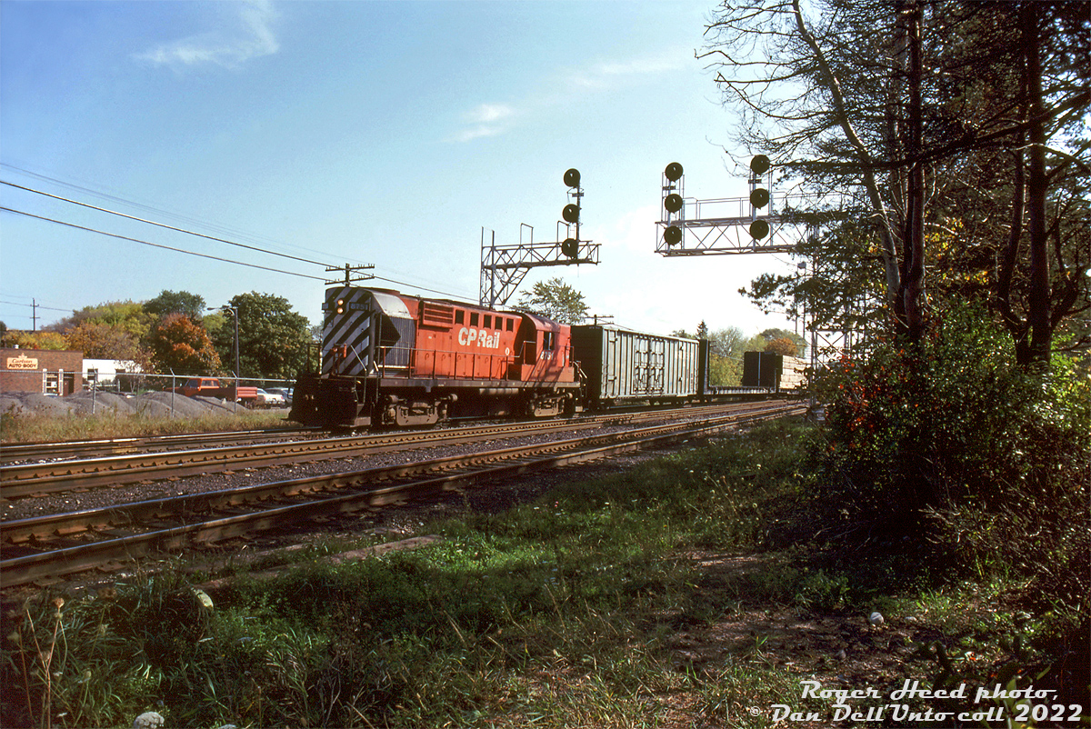 After making its way down the Owen Sound and Orangeville Subdivisions southbound (and switching the interchange track at Brampton enroute), "The Moonlight" has arrived at Streetsville Junction. CP RS18 8751 switches some cars at the south end of the yard, likely taking care of any duties at Streetsville before heading east on the Galt Sub for Toronto. 

Roger Heed photo, Dan Dell'Unto collection slide.
