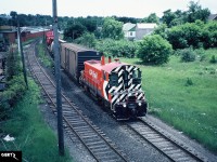 CP SW1200RS 8161 is viewed about to duck under the Galt Subdivision as it comes up to the Galt yard on the Simcoe Subdivision with cars from customers in Brantford. The customers were most likely Massey Combines and SC Johnson in Brantford on the former Lake Erie & Northern Railway. The track to the left was actually the CN Fergus Subdivision to Harrisburg, Ontario. 

