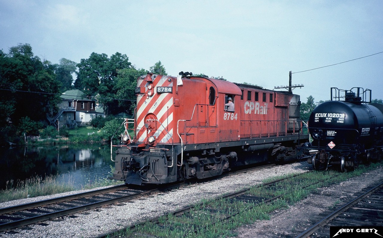 CP RS-18 8784 is rolling through the yard in downtown Guelph, Ontario along the Speed River in the summer of 1982. This unit eventually was rebuilt to CP RS-18u 1852 in March 1989.
