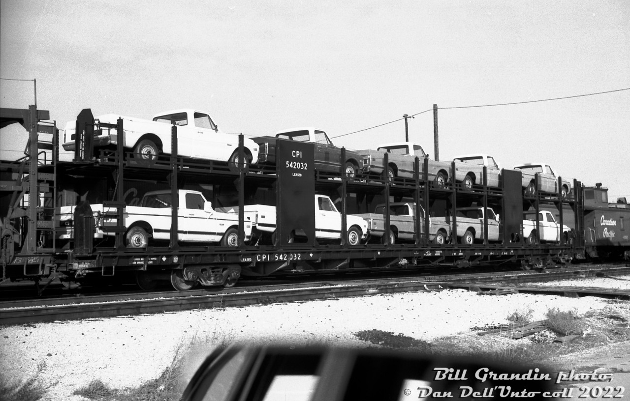 Back when vehicle loads were still visible to trackside bystanders: nearly new CPI 542032 (an 89' open bilevel autorack built by National Steel Car in 1968, CPI reporting marks meant duties were paid for international (I) service) sits in Canadian Pacific's Agincourt Yard loaded with new GMC pickup trucks, likely from the GM Oshawa plant. A wooden van sits coupled to the other end, possibly meaning this was a local or pickup job that recently arrived in the yard off CP's Belleville Sub.

Bill Grandin photo, Dan Dell'Unto collection negative.