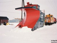 Awaiting it’s next call to duty on Canadian Pacific’s branchlines from Woodstock, CP plow 401005 is viewed at the Woodstock yard along with CP GP9u 8222 and “SOO Only” lettered caboose 434928 during a February winter morning.


