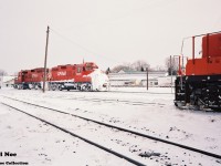 With evidence of a previous battle won on the CP branchlines from Woodstock, GP9u’s 8233 and 8234 depart the yard on the St. Thomas Subdivision light power during an early February morning as CP GP9u 8222 looks on. 