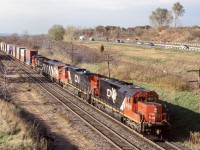 Much of the 2000’s proved to be a rewarding time to be a railfan. A lot of the older power was still kicking around and there was still a lot of variety as far as motive power went, especially on CN.  I quickly took a liking to CN’s rebuilt SD40U’s and tried to catch them when ever I could. While intermodal train 148 was the most reliable eastbound stack train on CN in Southern Ontario, the typically smaller 142 did often make an appearance. In later years it was abolished. It often seemed like 142 simply got the overflow traffic and any extra power needed to be moved back to Toronto. The Concept of the SD40U’s was to take a 1960’s locomotive and rebuild it to last a few more decades, this also included rebuilding the cab and angling the front windows to cut down the sun glare, similar to the GP9RM’s. CN would rebuild less then 30 units before deciding to turn to the second hand market for the rest of its SD40 needs. This day the sun was rapidly loosing against the incoming cloud cover as train 142 rolled through Aldershot with SD40U 6006 in the lead. Today the surviving SD40U’s spend their days deep within CN’s busy yards across the system, their mainline days now in the past.