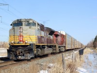 Being born in the mid 1970’s the first CP paint scheme I remember was action red. Nevertheless I always wished I could have photographed the maroon and grey era, especially scripted lettering. When CP released the heritage SD70ACU’s I was definitely hooked. Thanks to Athearn and it’s HO scale SD70ACU’s  7010 is now my favourite cp unit. I miss the old SD90 fleet but thanks to the SD70ACU program those unwanted units have received a second life, with some modifications. With word this day that 246 had 7010 in the lead it was enough to get me trackside. Thinking I would try a new spot this day I began my hike across a farmers field between ninth line and highway 407. Unfortunately I didn’t realize there was a small stream running under the snow and ice halfway across the field. It wasn’t long before I found myself through the ice in a foot and a half of water. I quickly abandoned that plan and sloshed my way back to the car and a more traditional shot several feet from the car. In the end the wet foot was worth it and the clouds cleared just in time for the train. Here 246 is seen rolling along the hydro corridor just west of Lisgar ago station.