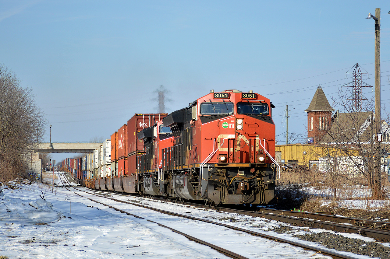 CN ET44AC #3051 leads 421 down and under, then back up again past the Merritt Street bridge in Merritton, which had a small trench dug for stacks to fit under the bridge after a serious miscalculation by RTC in the 90s caused CN 154 hit the bridge with double stacks. 

Nowadays CN 421 (especially this example!), 422, and even extras can be seen with long strings of double-stack containers on any of the 2 main tracks of the Grimsby Subdivision thanks to the addition.