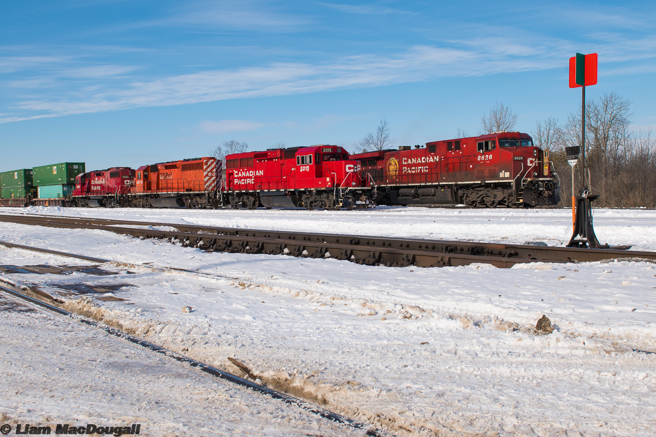 They say a picture speaks a thousand words, and this one certainly has a story behind it.

Here we see CP 9-118 and F55 beside each other at the east end of the yard in Smith’s Falls, Ontario. A trip was made out this way following word that a CWR would be running westbound with the SD40 pictured here at the helm, and a pair of KCS units that were dropped the previous night by 143. Upon arrival at the falls, we were surprised to see that the F55 crew had hooked their GP20ECO up to the aforementioned SD40 and were doing their day’s work with it. We knew F55 is the ID for the Omya (Glen Tay) turn, so we stuck around waiting to shoot the classic multimark GMD leading west on the job. Unfortunately, the waiting did not pay off as after they had built their train, they dropped the 40 and ran to the Omya plant long-hood-forward with their ECO unit…. Effectively, it was a day and upwards of $90 on gas money wasted.

As for the frame here, this was when F55 was in the process of spotting GP38-2 3051 on a cut of stacks for an eastbound to pick up later and bring towards Montreal. Meanwhile an extra 118 is backing up to drop off 2 cars. Something we took note of while being here is how CP seems to be using Smith’s Falls as a mini-classification yard, with 3 separate eastbounds having both pickups and setoffs at the yard with traffic that has nothing to do with surrounding industries, such as large cuts of intermodal.