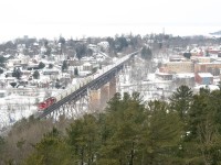 After a day of snowshoeing on Georgian Bay and grabbing beers to go at Trestle Brewing Co. (a must-visit, they've got a fantastic patio at the foot of the trestle), B and I decided to visit the hilltop museum and lookout tower before parting ways. We shot The Canadian from a trackside rock cut on the property; knowing there was a second northbound following, I decided to climb halfway up the tower to watch the freight roll by. B reluctantly followed and I explained the "golden goose" of Parry Sound shots - a genuine southbound crossing the trestle ACOT due to a detour or, as is far more common, faking the shot with an out-facing rear DPU—also a fairly lucky circumstance. <br>As luck would have it, I heard another engine rumbling up the line (check), it was at the end of the train (check!), it was a relatively fresh rebuild (Check!) and was facing out (CHECK!). I quickly climbed to the tower's summit and fired off a shot as it continued its northwestern journey. It's pretty amazing how quickly the distant landforms across the water fade into near-nothingness with a small amount of snow in the air.