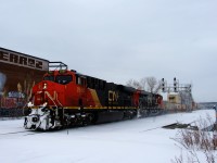 A snowstorm is dieing down, but it's still very cold and windy as CN 120 heads east with CN 2889 & CN 3845 up front.