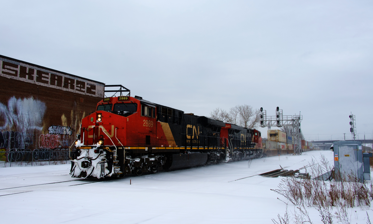 A snowstorm is dieing down, but it's still very cold and windy as CN 120 heads east with CN 2889 & CN 3845 up front.