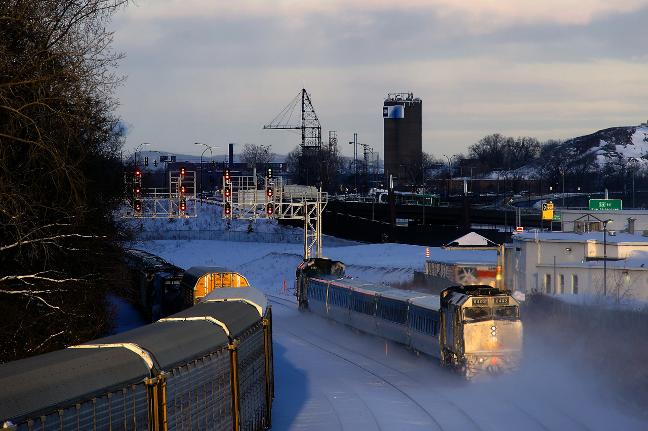 VIA 64 is about to knock down a clear signal on the frigid afternoon after a big snowstorm hit Montreal. VIA 6412 is leading and wrapped VIA 6402 brings up the rear. At left is CN 372, changing crews nearby at Turcot Ouest.