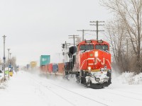 CN 108 is passing through Dorval Station with CN 3861 up front and CN 2220 on the tail end. In the distance, VIA 24 is approaching on the south track.