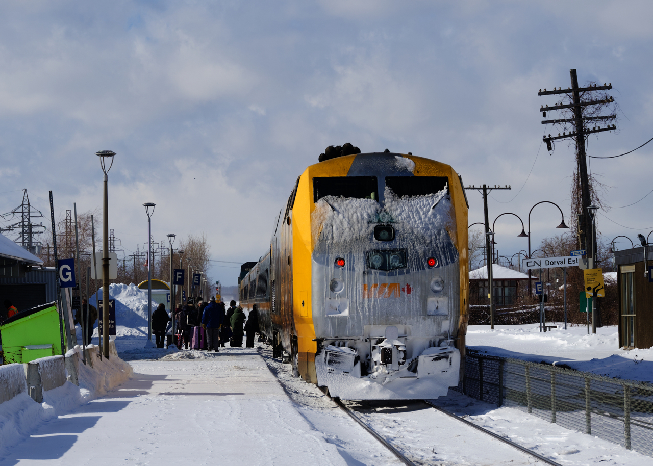 Passengers board VIA 35 at Dorval Station during a brief sunny period.