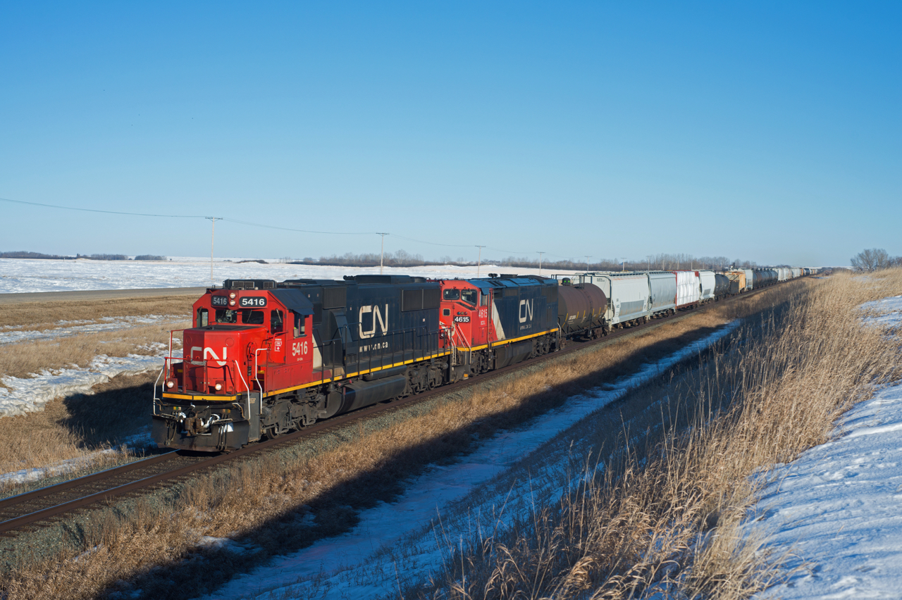 After sitting in the yard at Biggar for the majority of the day, CN 401 still managed to make it out in some sweet light. CN 5416 and BCOL 4615 made up an equally sweet consist. The train is seen here on the first few miles of the Wainwright Subdivision better Oban and Palo Saskatchewan.