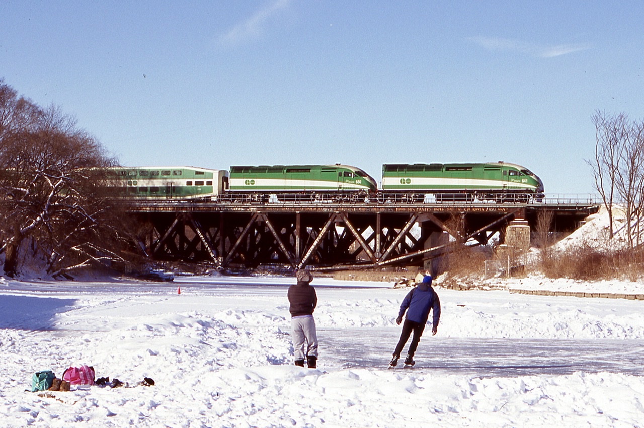 I’m not much for wandering around on frozen rivers but I didn’t want to lose the chance of framing some Canadian winter activities in front of a passing GO train. A full on hockey game would have definitely made the shot but unfortunately they cleared the ice before I arrived. I have always liked this unique bridge in Port Credit and it’s unfortunate that these days it is almost impossible to capture a freight train of any kind in daylight here. It’s hard to believe there were once numerous rail servers industries in Port Credit, especially Texaco and St. Lawrence starch, now all history as the town is now more focused on tourism like so many other lakeside towns in the region.