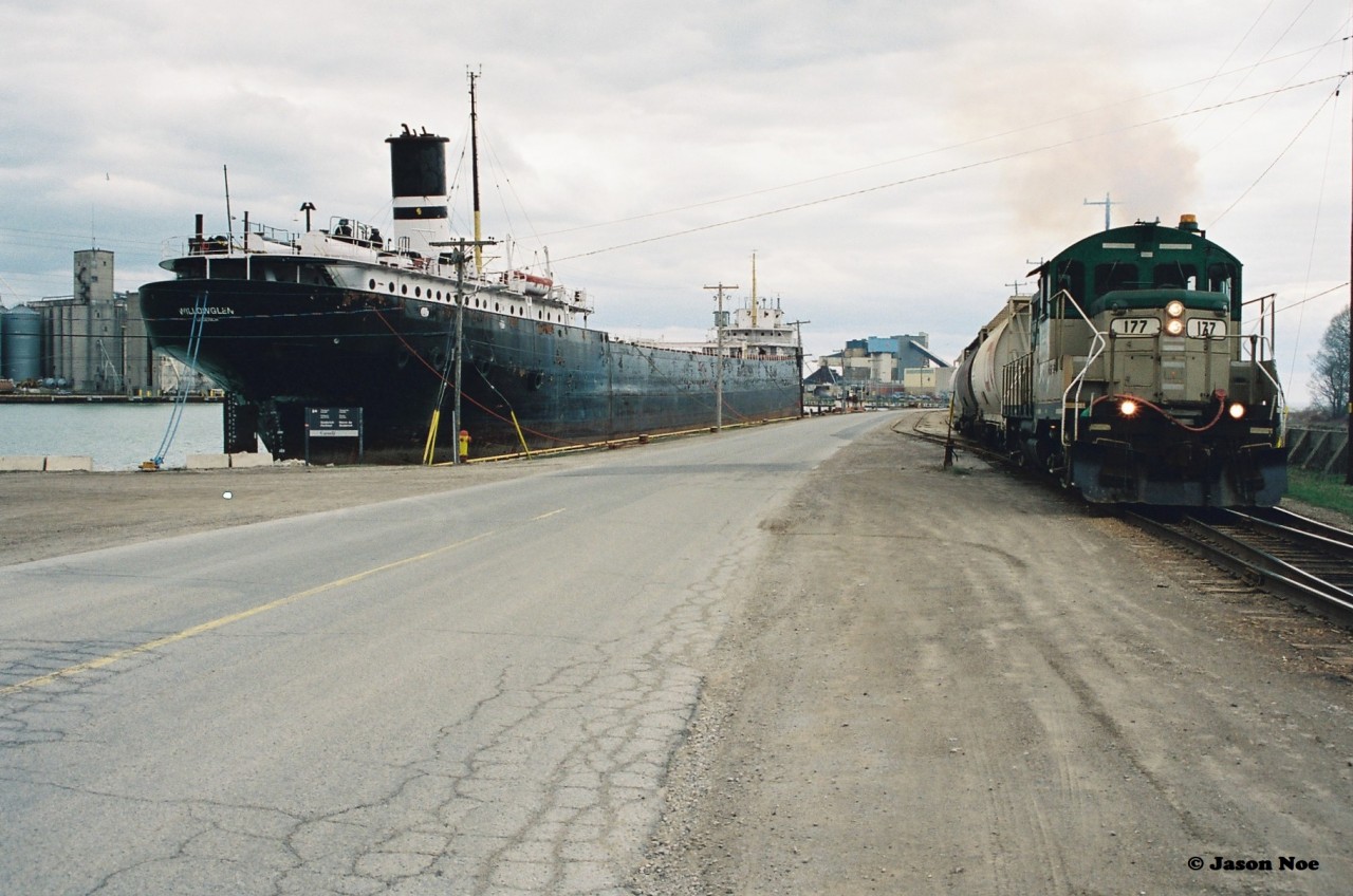 Goderich-Exeter Railway (GEXR) GP9 177, departs the large Sifto Salt mine in Goderich, Ontario with three hoppers and heads up the steep grade towards the yard on April 28, 1995. The former Cartier Railway unit would operate on GEXR until 2002, after a damaged main generator sidelined it for good.