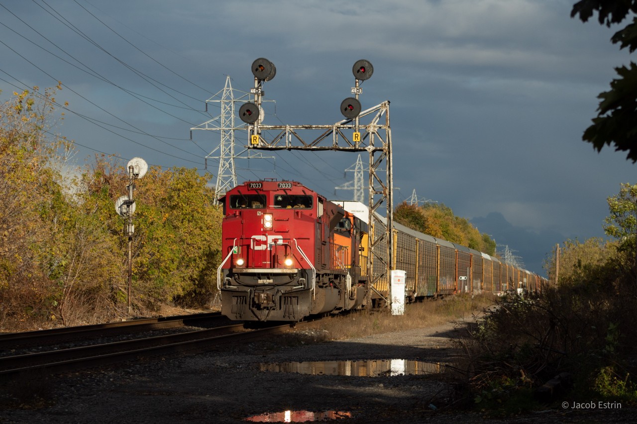 CP 7033 as well as a BNSF gevo are in the lead of 147-02 as it passes through Bartlett on a beautiful fall evening.