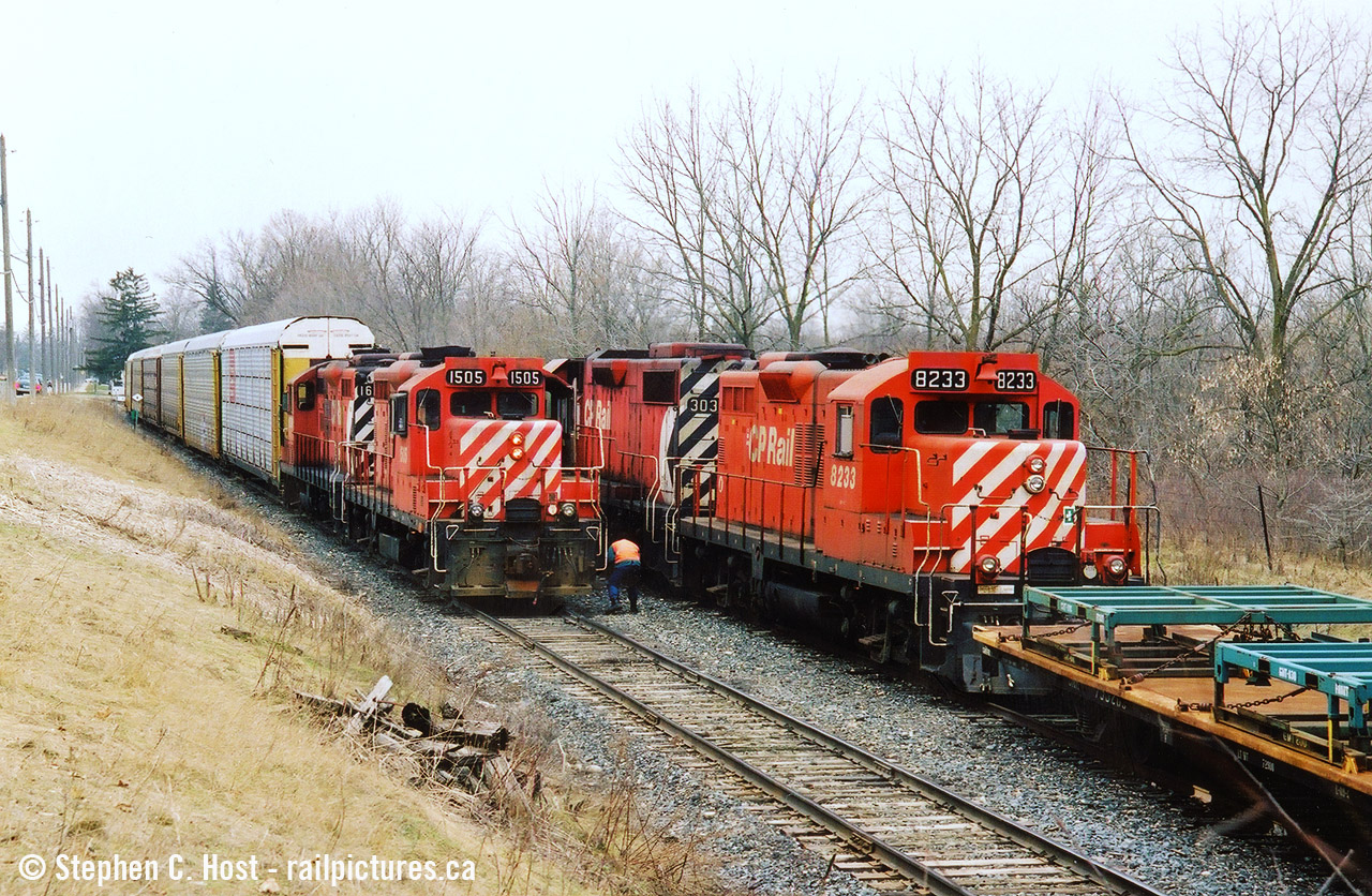 Two friends and I went out in March 2004 to the Ingersoll/Woodstock area for trains, one of my favourite spots: CN and CP are close by along with NS 327/8. Plus you had the frame train, an afternoon favourite as they would usually come during the afternoon lull. Imagine our surprise when the Frame Train is getting a clearance on the CPR St. Thomas sub from the RTC then they say "Proceed from Mile 0.7 to East Siding Switch Beachville, clear main track".... clear main track? The frame train? For what? Let's go.... We didn't have to go too far and with TK12 coming back from CAMI with a long cut of cars, the Frame Train had to take the siding as they would fit. From what I recall meets here were very rare and I'd only have heard of it on two or three occasions in this era basically per year. Photo notes: Scanned (by Jacob) from a print and originally on Fuji Provia film. It was this outing and the next one in Sudbury later that month that basically pushed me to get a DSLR in a couple weeks time and never look back.
Bonus: Here's us watching it all unfold by David Graham: here  and a Video of the meet too. These were the days.... and for the most part this line was basically ignored by most - this was every day stuff.