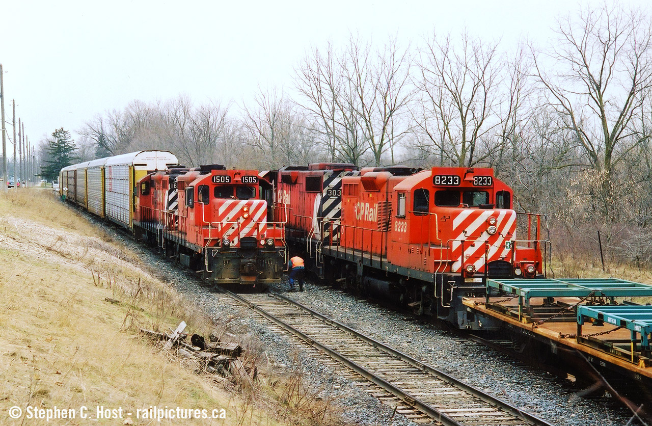 Two friends and I went out in March 2004 to the Ingersoll/Woodstock area for trains, one of my favourite spots: CN and CP are close by along with NS 327/8. Plus you had the frame train, an afternoon favourite as they would usually come during the afternoon lull. Imagine our surprise when the Frame Train is getting a clearance on the CPR St. Thomas sub from the RTC then they say "Proceed from Mile 0.7 to East Siding Switch Beachville, clear main track".... clear main track? The frame train? For what? Let's go.... We didn't have to go too far and with TK12 coming back from CAMI with a long cut of cars, the Frame Train had to take the siding as they would fit. From what I recall meets here were very rare and I'd only have heard of it on two or three occasions in this era basically per year. Photo notes: Scanned (by Jacob) from a print and originally on Fuji Provia film. It was this outing and the next one in Sudbury later that month that basically pushed me to get a DSLR in a couple weeks time and never look back.
Bonus: Here's us watching it all unfold by David Graham: here  and a Video of the meet too. These were the days.... and for the most part this line was basically ignored by most - this was every day stuff.