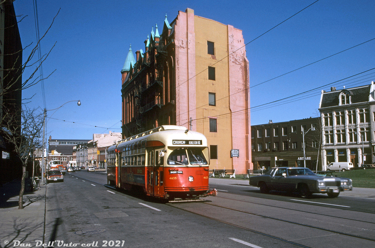 TTC PCC 4635 (an A11-class ex-Cleveland car) operates on the Kingston Road route short-turning at Church, heading westbound on Wellington Street just past Church Street (looping via Church-Wellington-York, then east on Queen and back to Kingston Rd). This area of downtown Toronto east of Yonge Street is known as the St. Lawrence Neighbourhood, home to the iconic Gooderham Flatiron building (behind 4635), and the St. Lawrence Market visible in the distance. Much of the old heritage buildings in this area have been retained, and the old Gooderham Flatiron has become a favourite for local urban photographers.

Original photographer unknown, Dan Dell'Unto collection slide.