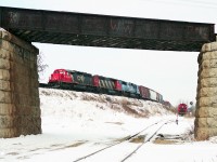 At Brant Junction the Burford spur heads south to the old industrial area of Brantford, and the Dunnville Sub to Caledonia and Fort Erie passes overhead on an old stone and iron bridge.  A westbound freight led by CN6006 and a Conrail loco passes by on the Dundas sub, while the switcher waits for clearance to return to Brantford yard, 8/10 mile west.  February 1994