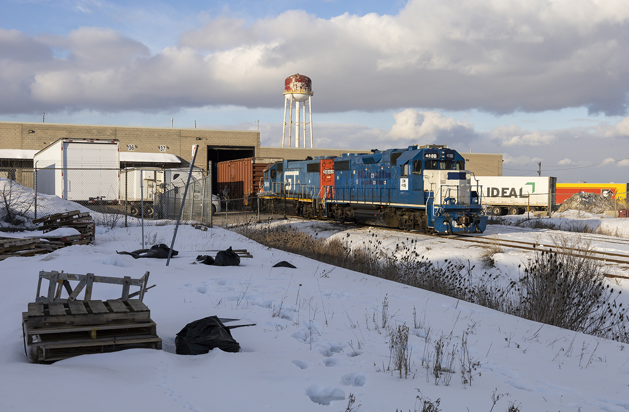 One of CN's... interesting acquisitions paired with a GTW lift some boxcars from XLT Transport at Etobicoke North. The patch work is pitifully hilarious on the lead unit, one may wonder when it will get a fresh coat of CN website red.