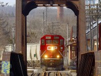 On its way to Havelock and Blue Mountain to serve the nepheline syenite mine, CP train T08 passes Peterborough station (built 1884) and crosses the Otonabee River bridge (built 1913) on March 9th, 2021.  The usual power is three locomotives, today led by GP20C-ECO 2259.