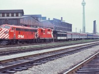 <br>
<br>
  Oh! If you hang around long enough....
<br>
<br>
   The presence of a steam generator equipped, western based, CP Rail  Geep 9  on VIA #1 indicates a regular 1400 series F unit required replacement. The 8512 is the future 1513 (Winnipeg).
<br>
<br>
   The daily VIA #1 is traversing the CN Weston Subdivision and in under one mile, at Parkdale, will swing north on to the Newmarket Subdivision.
<br>
<br>
   Next to the Budd built baggage dormitory car, that Manor series sleeping car is in crew dormitory service. And that car in VIA livery is likely a 5700 series Dayniter coach.
<br>
<br>
   On the right is the CP Rail Galt Subdivision – the regular daily route of the CPR The Canadian.
<br>
<br>
   On the approach to Parkdale, with ex CP Rail 1413 and CP Rail 8512  with ex CP Rail Algonquin Park gracing the tail end of  VIA #1, May 6, 1979 Kodachrome by S. Danko
<br>
<br>
   Notable: 
<br>
<br>
   The former Massey – Ferguson ( Massey – Harris) agricultural implement manufacturing plant is vacant and the buildings today are long gone....note the Bathurst Street bridge beyond the Strachan Ave crossing guard's control tower
<br>
<br>
     <a href="http://www.railpictures.ca/?attachment_id= 48084 ">  tail end  </a>
<br>
<br>
     <a href="http://www.railpictures.ca/?attachment_id=  6218 ">  CP 8511 on #1  </a>
<br>
<br>
   sdfourty


