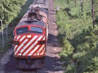 <br>
<br>
   Candy Stripes in foreign territory: GMD 1953 built FP7A, ex CP Rail, #1404 & a sister in charge of VIA #1 ...
<br>
<br>
   … on final approach to the CN Newmarket station stop, June 2, 1979 Kodachrome by S.Danko
<br>
<br>
   Noteworthy: In this image the VIA Train #1 – CANADIAN -  has only 15 remaining daily trips on the CN Newmarket Sub (south of Washago and from Washago north on the Bala Sub to CN Boyne (CP Rail Reynolds) near South Parry).
<br>
<br>
    The June 17, 1979 timetable re-routed the daily VIA #1 & 2  CANADIAN exclusively onto CP RAIL Vancouver (CN station) through Banff to/from Montreal (CN) Central Station. 
<br>
<br>
   and concurrently daily trains  #3 & 4  SUPER CONTINENTAL exclusively on CN Vancouver through Jasper to/from Toronto Union. 
<br>
<br>
   VIA trains 1 & 2, 3 & 4: The June  17 1979 re-routings were only in place a couple of years, by June 1982 the SUPER CONTINENAL disappeared completely, replaced by 10 regional trains.
<br>
<br>
   VIA #1 & 2 remained on CP RAIL through to the January 1990 debacle that slashed more than half of VIA services – thanks to YOUR Canadian Federal Government 
<br>
<br>
   Ponder: Wasn't VIA's original purpose to promote rail passenger travel ? However all VIA has done is reduce / divest services and continues to do so.....hmmm....
 <br>
<br>
  Foreign: 
<br>
<br>
     <a href="http://www.railpictures.ca/?attachment_id= 8558 "> bemused </a>
<br>
<br>
   sdfourty

